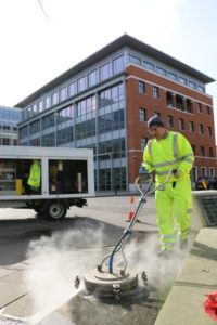 Commercial services team power washing pavement