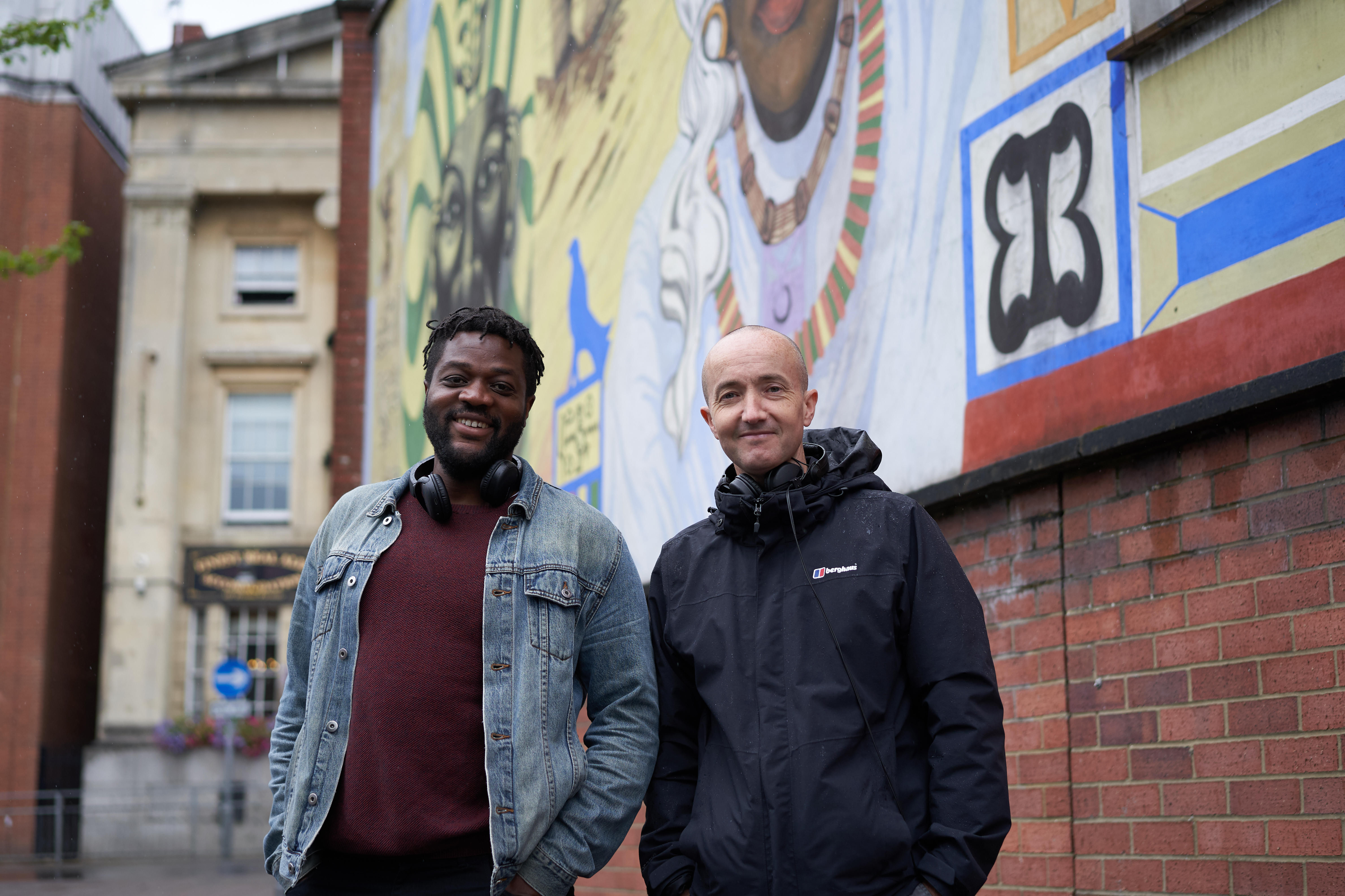 Aundre Goddard and Richard Bentley stood in front of the Central Club mural