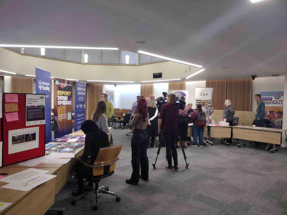 People looking around display stalls at a Safer Streets event in the Council Chambers