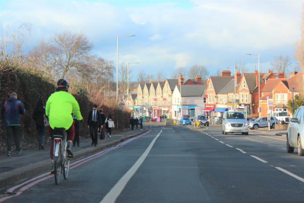 Cyclist riding on cycle path on Wokingham Road.