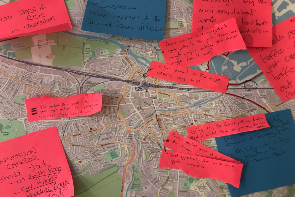 Brightly coloured sticky notes with writing on stuck to map of Reading.