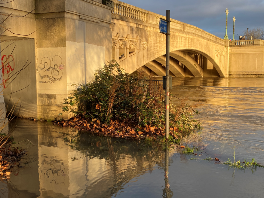 Reading Bridge as seen from Christchurch Meadows, where the river has burst its banks due to flooding. The footpath is submurged by water.