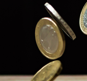 Coins falling on a table.