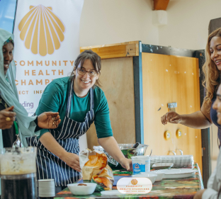 People preparing food around a table.