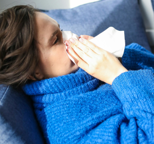 Woman blowing her nose.