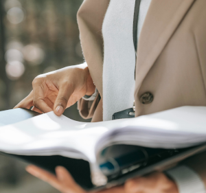 Person leafing through a file of papers.