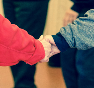 Two people holding hands.