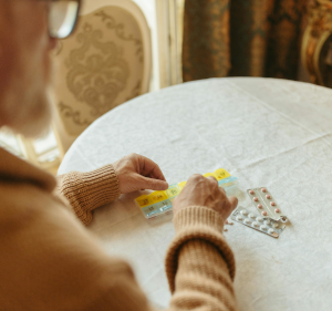 Person sorting pills on a table.