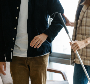 One person handing another a stick.