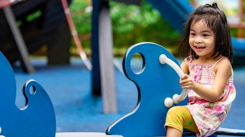 Young girl on springie play equipment