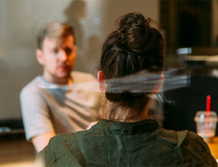 photo of two adults having a conversation in a cafe