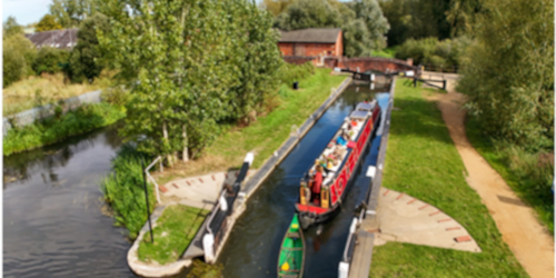 Aerial photograph showing narrowboat and kayak entering a lock on the Kennet Canal.