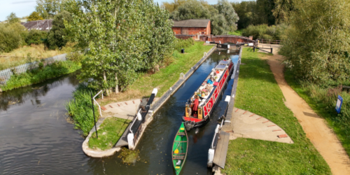 Aerial photograph showing narrowboat and kayak entering a lock on the Kennet Canal.