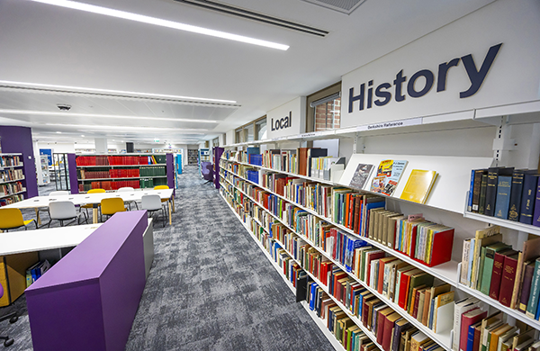 Local History section of the library with shelves of reference books, study tables, and a quiet space for research and reading.