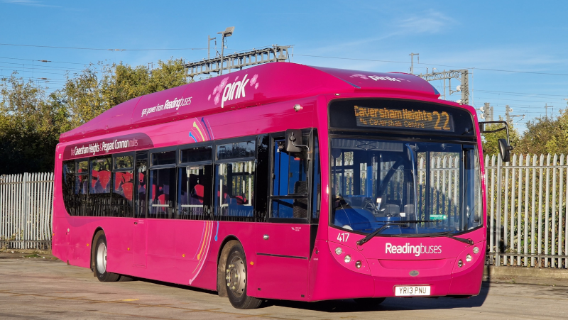 A bright pink single-decker bus operated by Reading Buses, branded 'pink', displaying route 22 to Caversham Heights via Caversham Centre on its front destination screen. The bus, numbered 417 with registration YR13 PNU, is parked in a depot yard with metal railings and trees in the background.